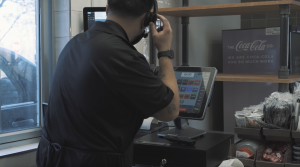 Burrito Parrilla worker in the drivethru window using ACRELEC OrderMatic 